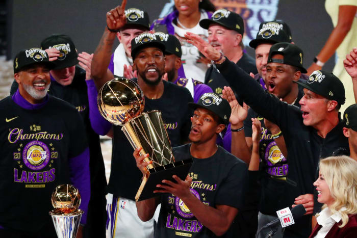 Los Angeles Lakers guard Rajon Rondo (9) holds the trophy as he celebrates with teammates after game six of the 2020 NBA Finals. The Oak Hill
